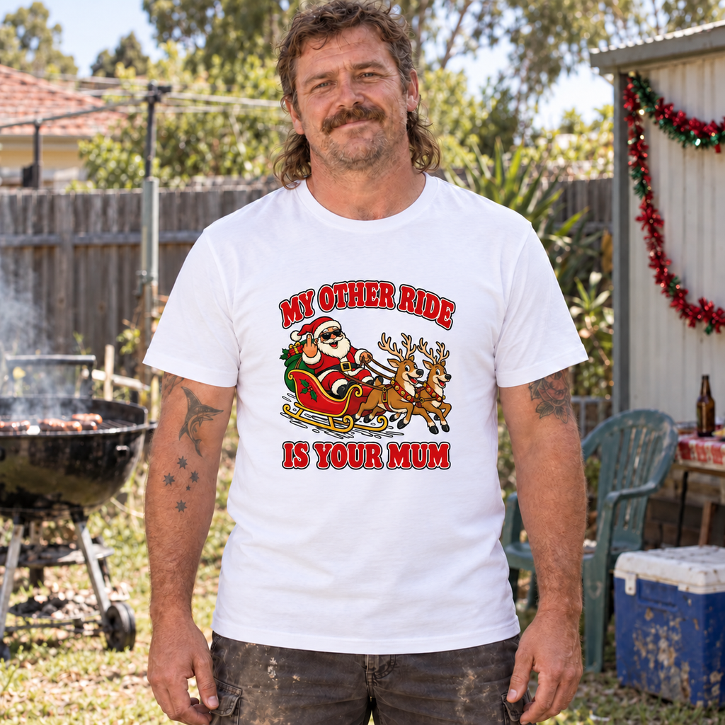 Man wearing a white My Other Ride Is Your Mum tee with red lettering and a cartoon Santa sleigh and two reindeer.